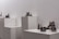 Close-up of diverse textured sculptures displayed in a minimalist gallery setting.