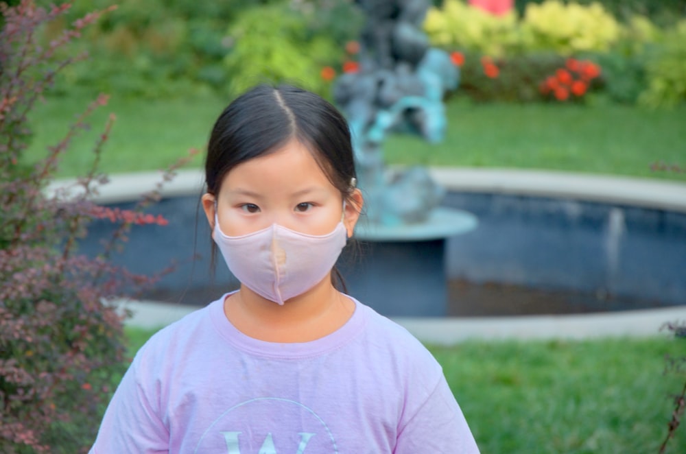 woman in white crew neck t-shirt wearing white face mask