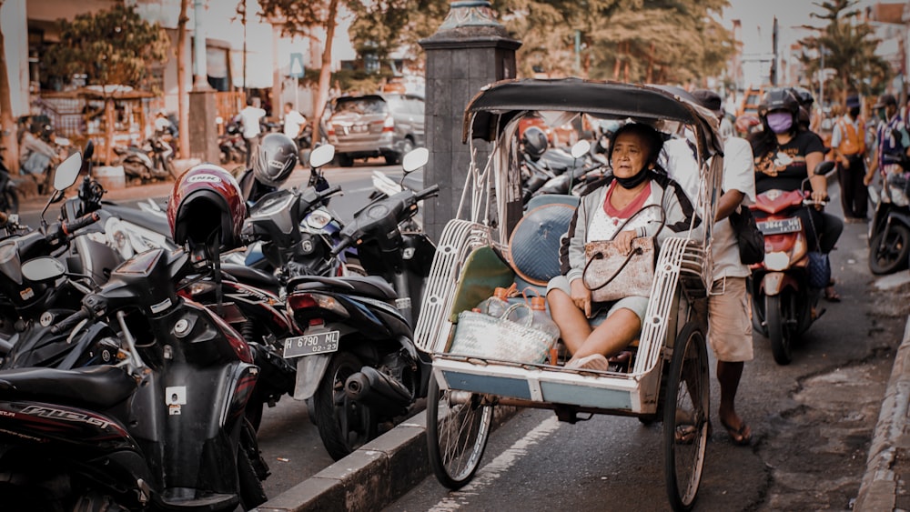 2 men and woman riding on black motorcycle during daytime