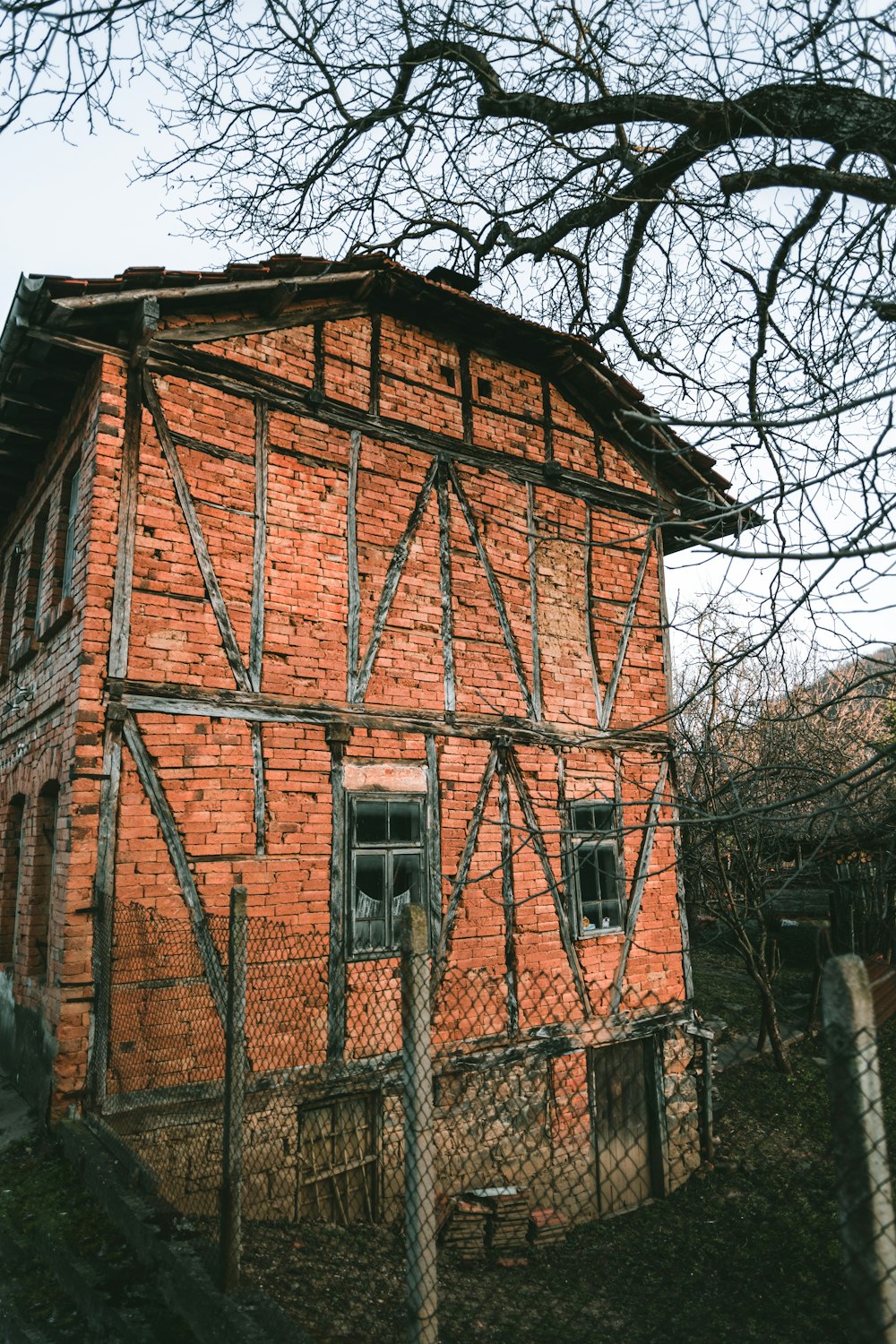 brown brick building near bare trees during daytime