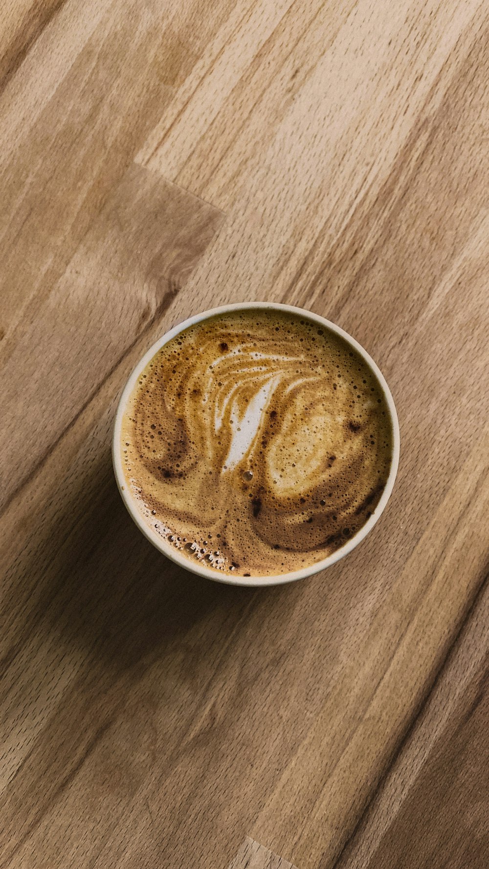 white ceramic mug with brown liquid