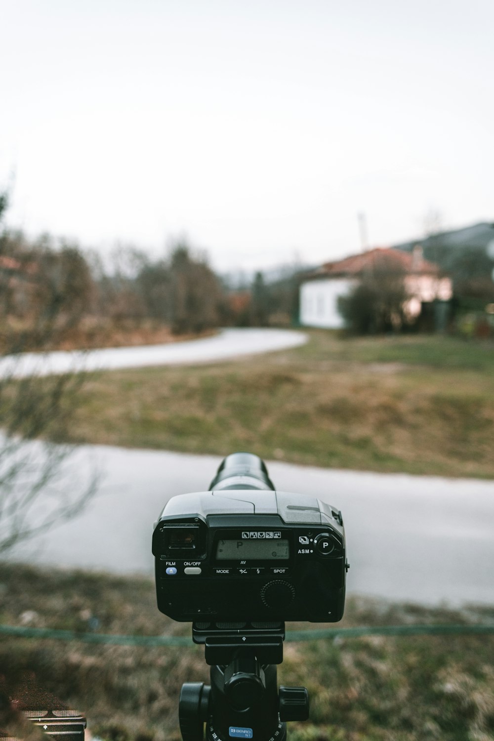 black dslr camera on road during daytime