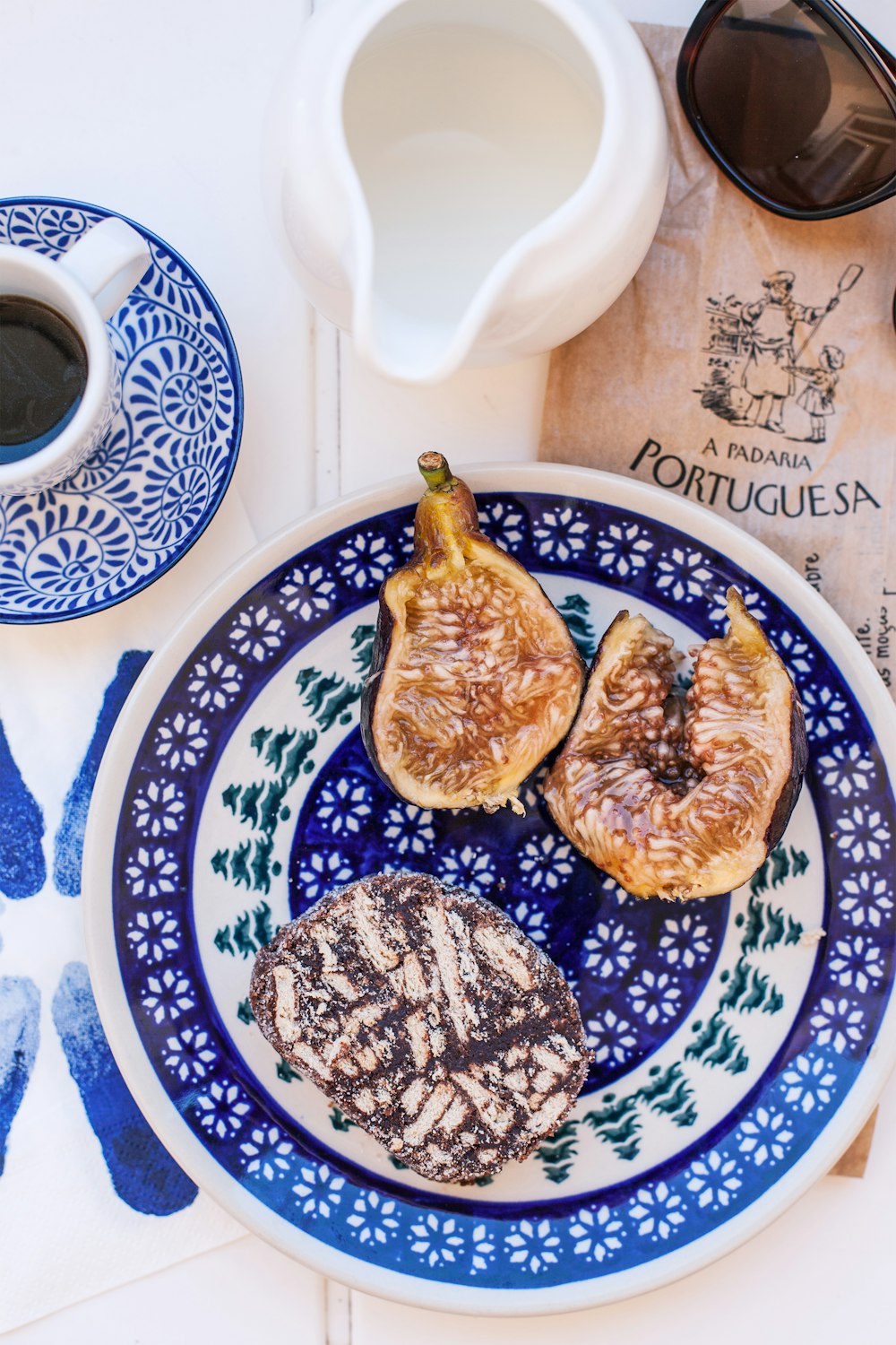 two brown and white pastries on blue and white floral ceramic plate