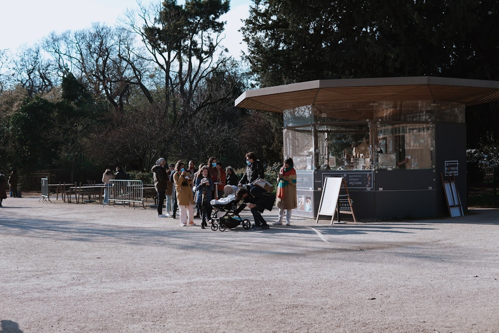 people sitting on bench near building during daytime