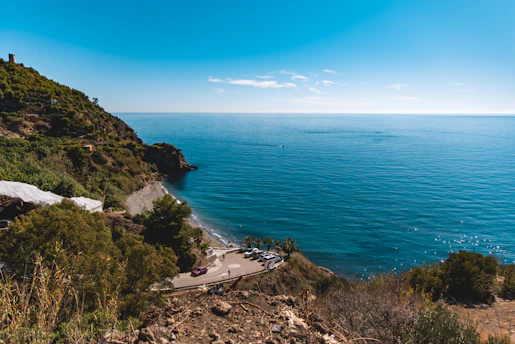 A scenic coastal parking spot near a beautiful Algarve beach with clear blue waters.