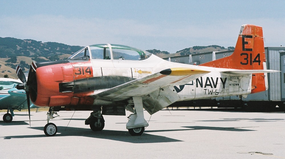 white and red air plane on airport during daytime