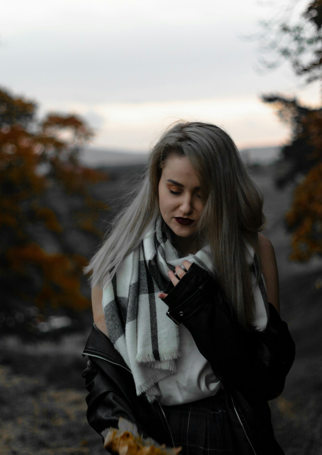 woman in black and white scarf and black leather jacket