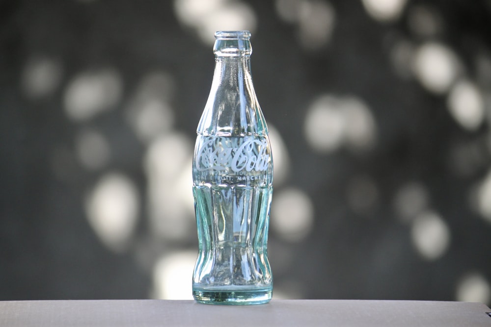 clear glass bottle on white table