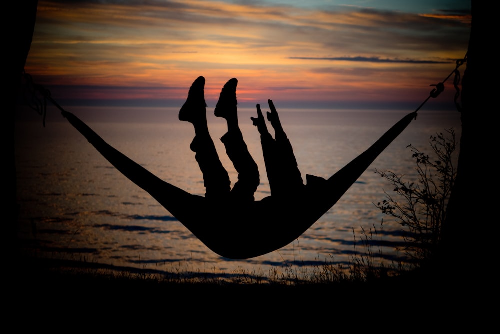 silhouette of person doing yoga during sunset