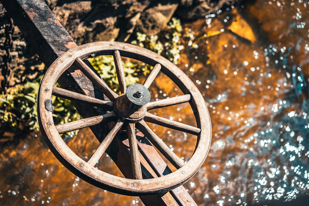 black metal wheel on brown wooden surface