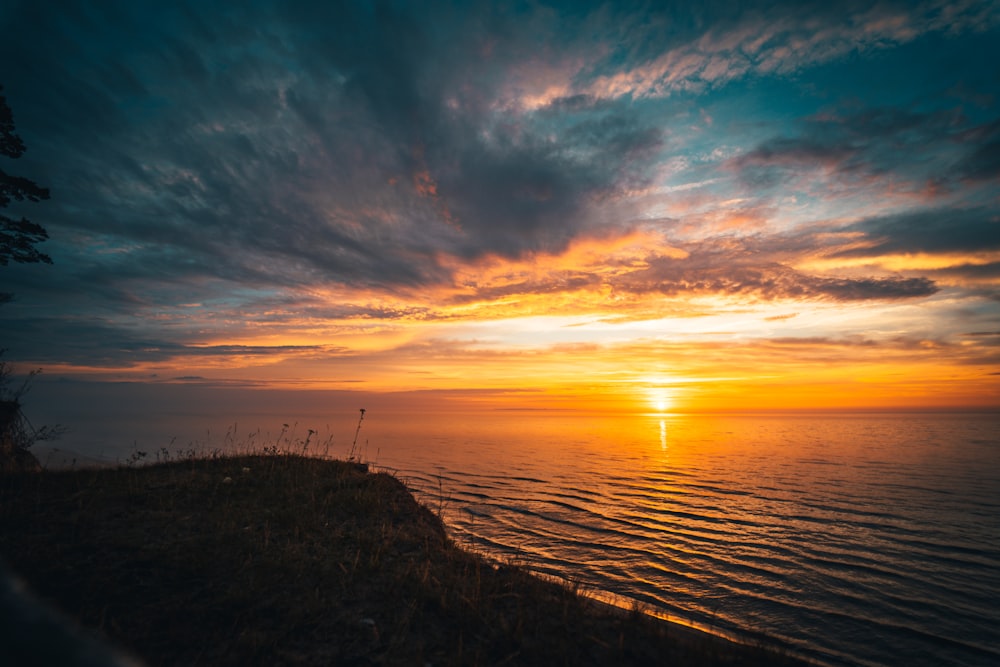 body of water during sunset