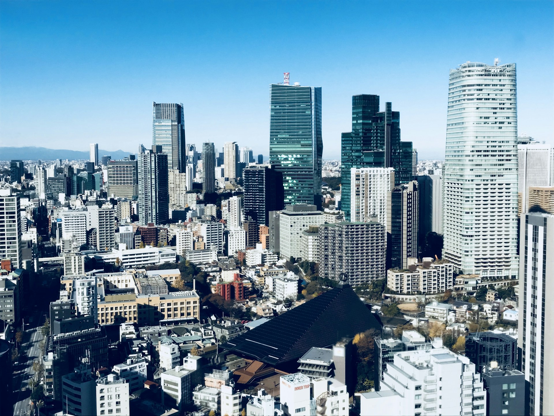 A panoramic view of the bustling cityscape of Visakhapatnam, highlighting the blend of modern buildings and local culture under a clear blue sky.