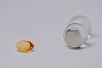A close-up of natural herbal capsules on a wooden surface.