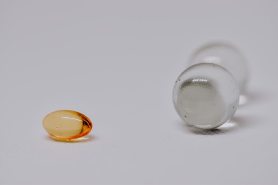 A close-up of natural herbal capsules on a wooden surface.