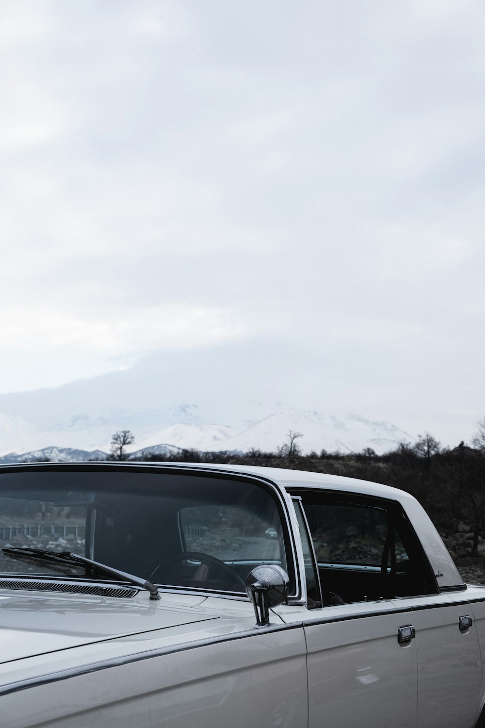 black car on snow covered ground during daytime