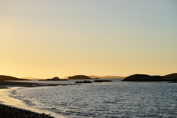 A serene Mediterranean coastline at sunset, highlighting natural beauty and calm.
