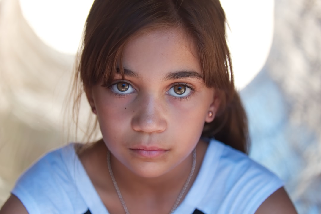 girl in white crew neck shirt wearing silver necklace