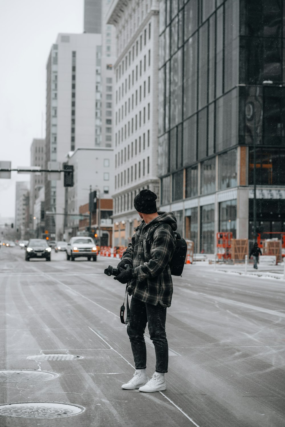 man in black jacket and black pants walking on street during daytime