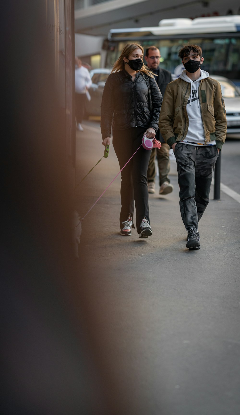 man in black jacket and gray pants walking on hallway