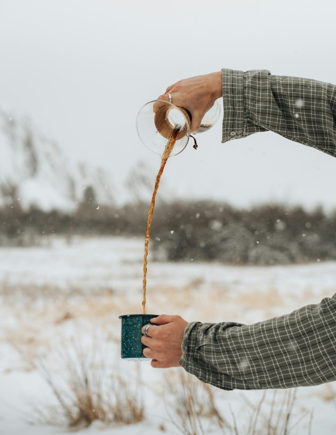 person holding green ceramic mug with brown rope