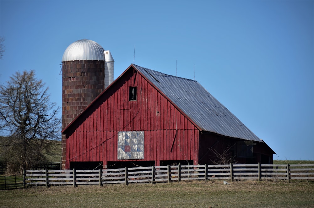 red and gray barn under blue sky during daytime