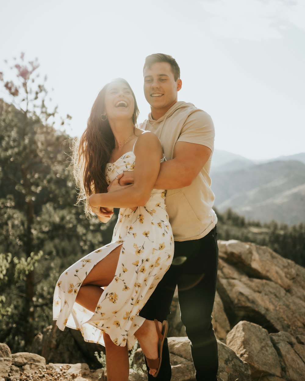 man in white dress shirt hugging woman in white and black polka dots dress