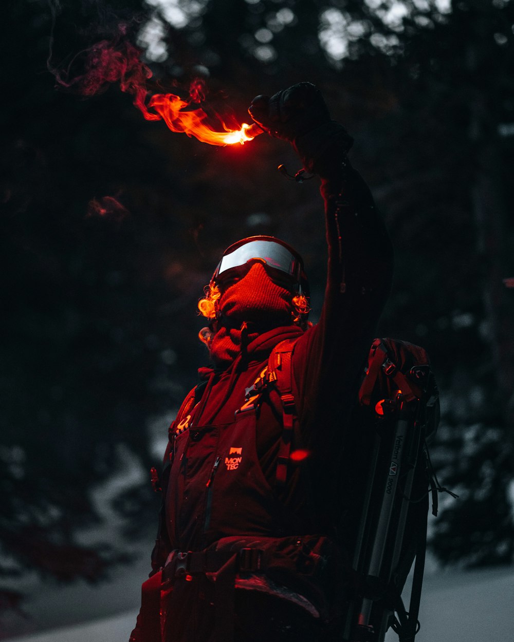 man in brown jacket holding fire