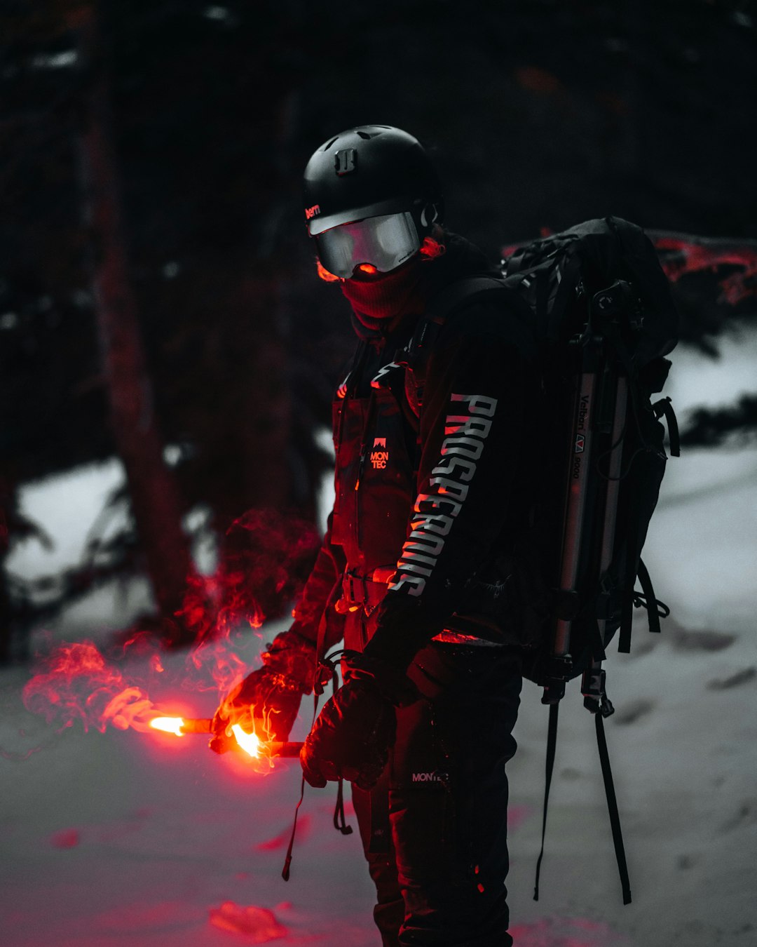 man in red and white jacket and black helmet standing on snow covered ground during daytime