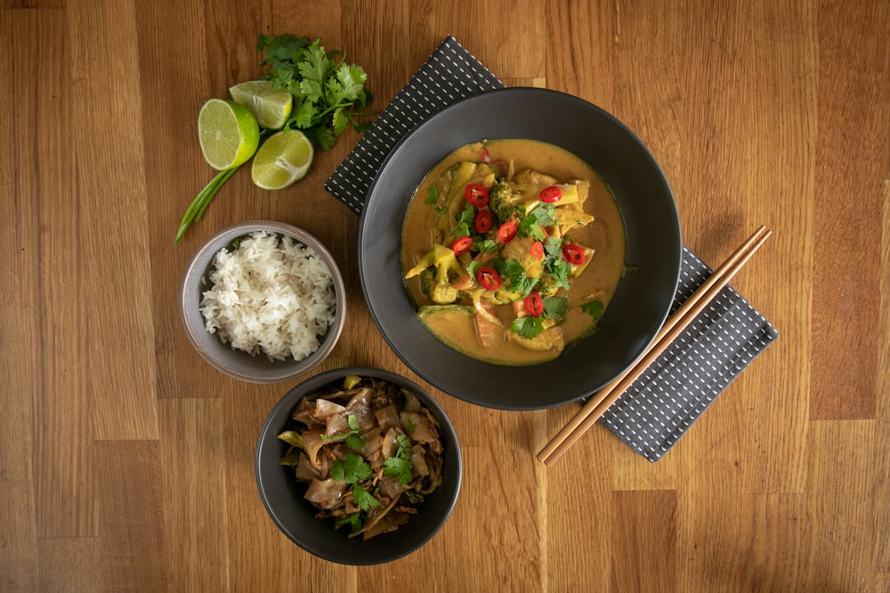 black ceramic bowl with rice and sliced lemon