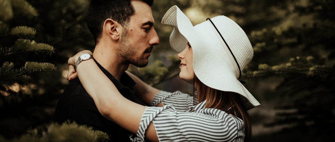 man and woman kissing during daytime