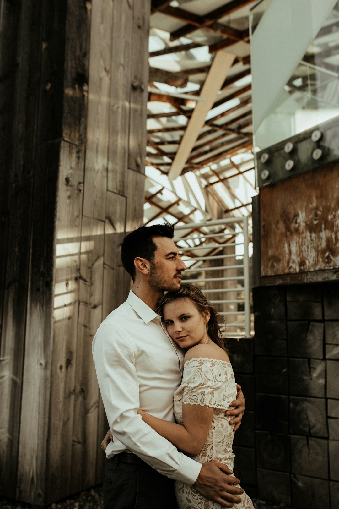 man in white dress shirt standing beside woman in brown and white floral dress