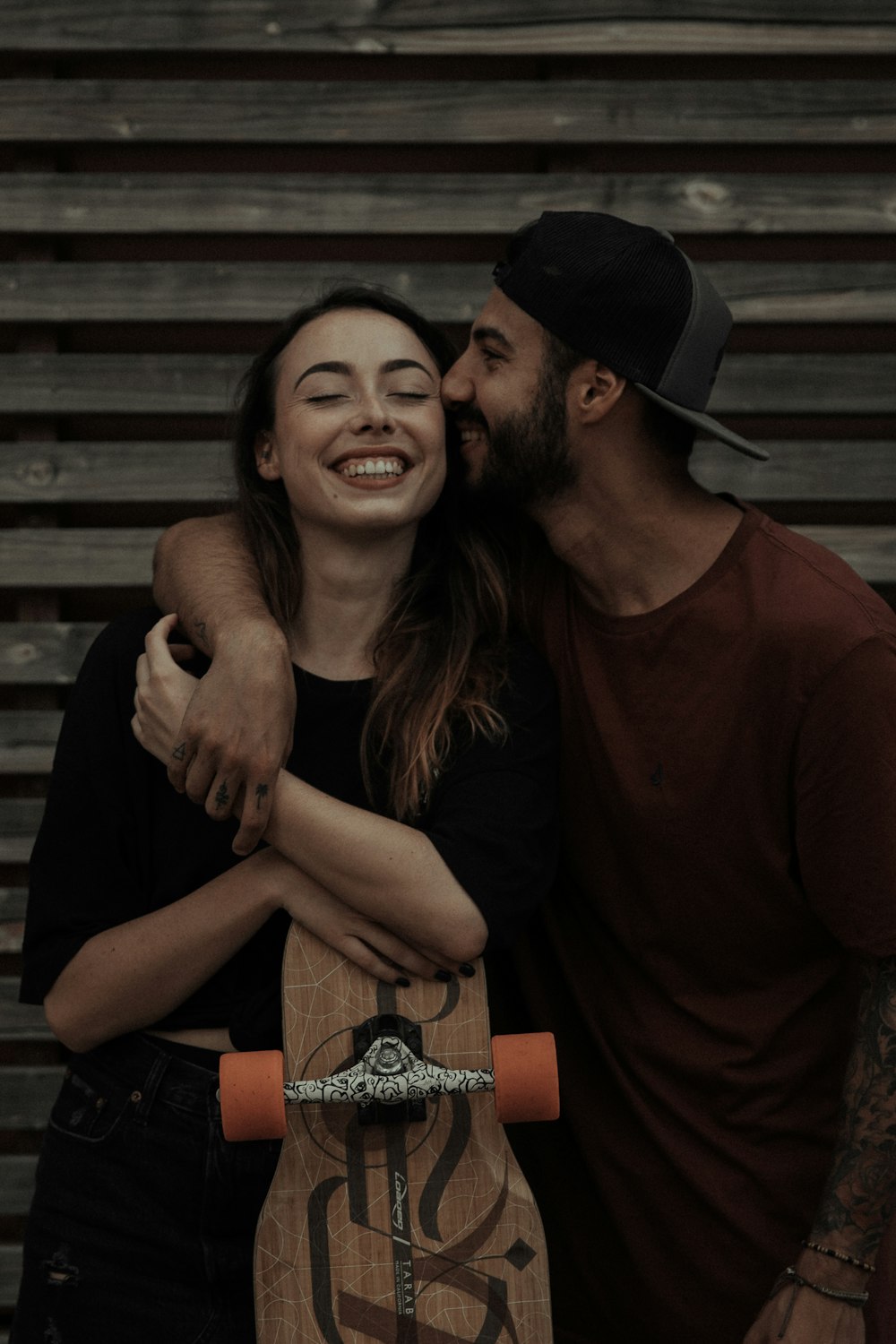 man in red long sleeve shirt beside woman in black dress