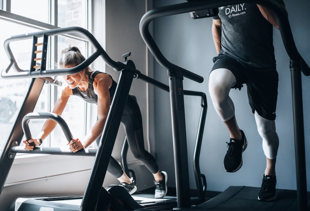 woman in black tank top and black shorts sitting on black exercise equipment