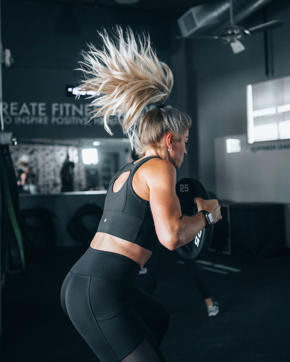 woman in black sports bra and black leggings doing exercise