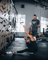 woman in black tank top and black leggings doing yoga