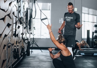 woman in black tank top and black leggings doing yoga