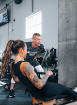 a man and a woman working out in a gym