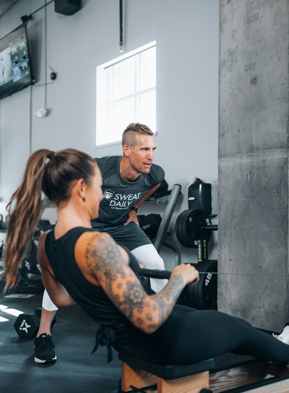 a man and a woman working out in a gym