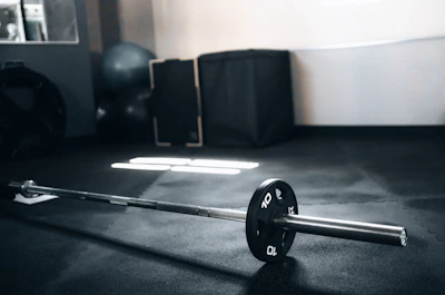 Side view of gym equipment resting securely on thick rubber roll flooring.