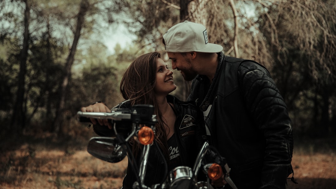 man and woman riding motorcycle during daytime