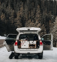 A family SUV ready for a weekend trip, shown with open doors and luggage.