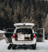 A family loading luggage into a spacious SUV in a scenic outdoor location.