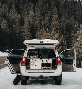 A spacious SUV ready for a family road trip with luggage on the roof.