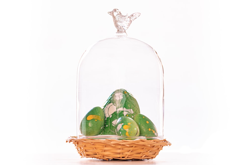 green and yellow egg in clear glass bowl