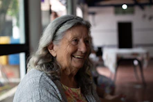 smiling woman in gray cardigan