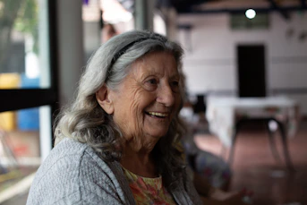 smiling woman in gray cardigan