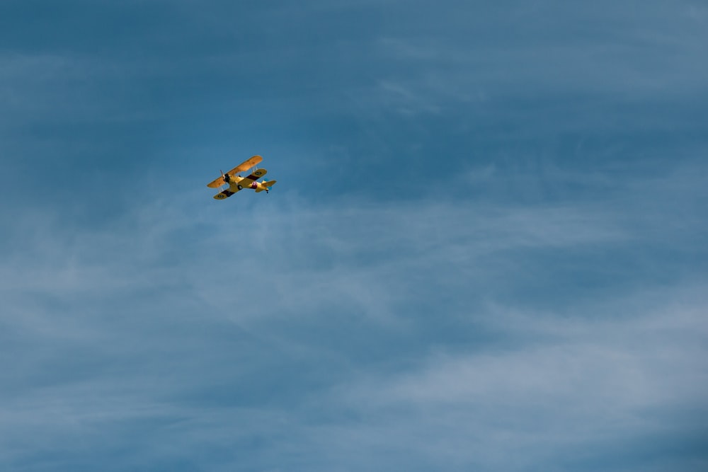 brown and black plane flying in the sky