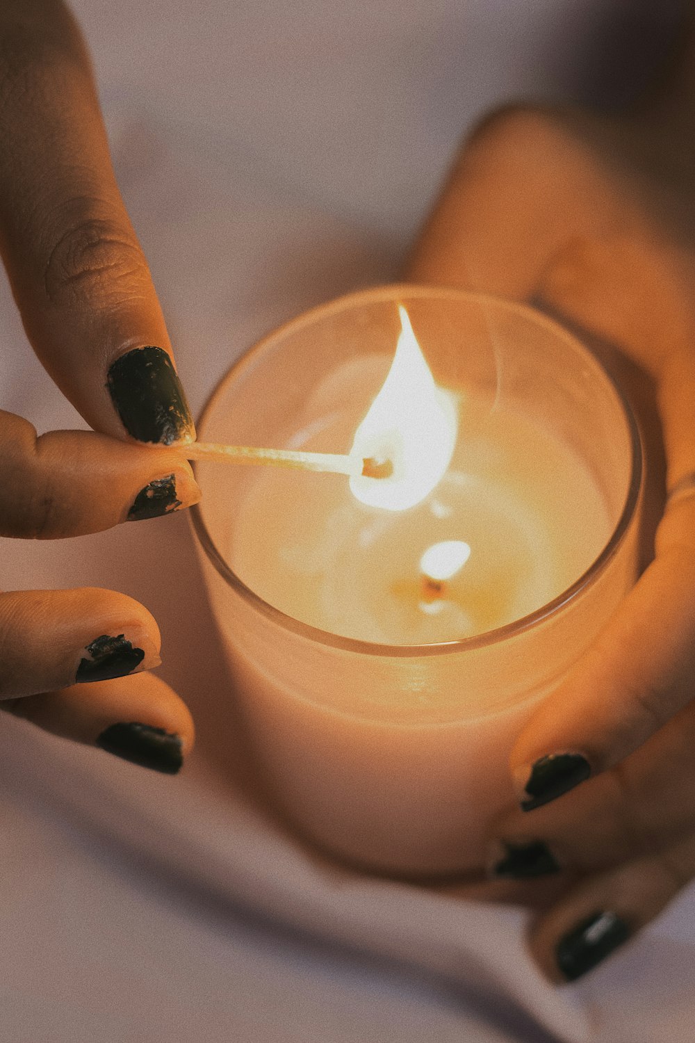 person holding lighted candle stick