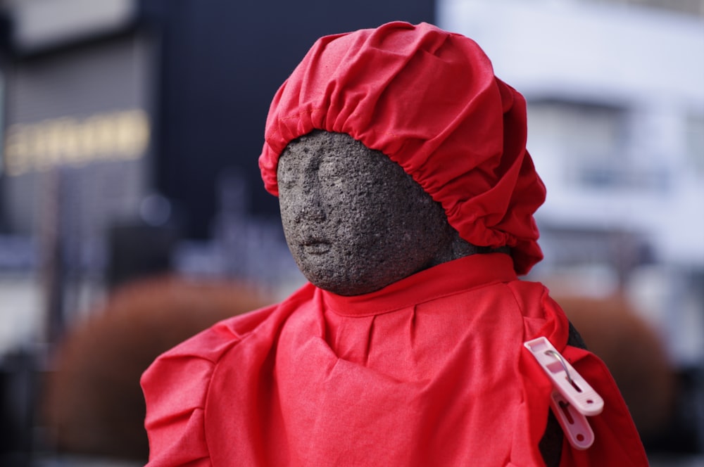 Person in rotem Kapuzenpullover mit grauer Strickmütze