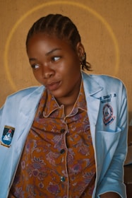 woman in white button up shirt wearing orange and blue floral scarf